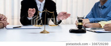 Focused gavel hammer and balance scale of justice on blurred background. Rigid 108720280