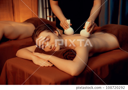 Hot herbal ball spa massage body treatment with couple customer. Quiescent 108720292