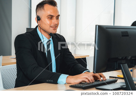 Business people wearing headset working in office Jivy 108720324