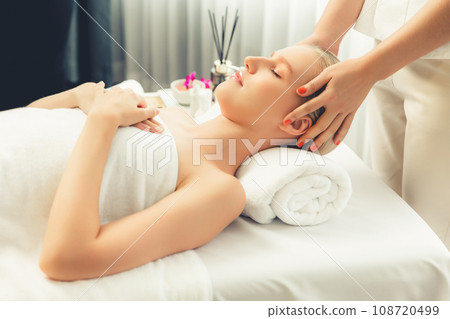 Caucasian woman enjoying relaxing anti-stress head massage. Quiescent Caucasian woman enjoying relaxing anti-stress head massage. Quiescent 108720499