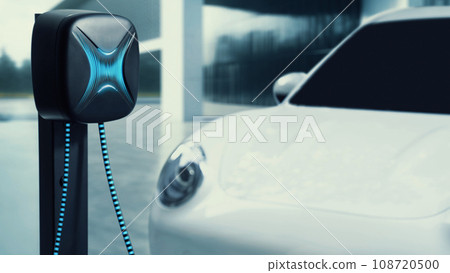 Electric car recharge to charging station with future building. Peruse Electric car recharge to charging station with future building. Peruse 108720500