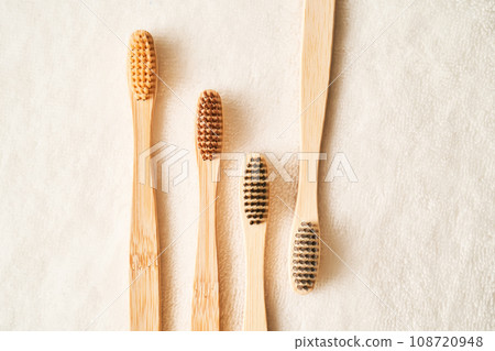 Toothbrushes on a white terry towel. 108720948