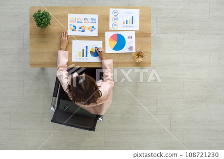 Professional woman analyzing data at a modern workplace. Top view 108721230
