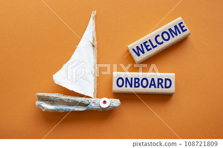 Welcome onboard symbol. Concept words Welcome onboard on wooden blocks. Beautiful orange background with boat. Business and Welcome onboard concept. Copy space. 108721809