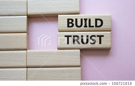 Build trust symbol. Wooden blocks with words Build trust. Beautiful pink background. Business and Build trust concept. Copy space. 108721818