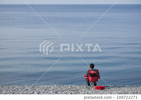 A man fishing in the sea on the coast in the morning A man fishing in the sea on the coast in the morning 108722271