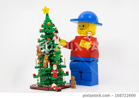giant man help to decorate the christmas tree in Christmas party. giant man help to decorate the christmas tree in Christmas party. 108722600