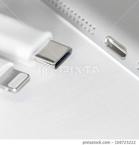 View of apple device with both usb-c and lightning cable charger. Eu forced Apple iphone to Use usb-c instead of lighting cable. View of apple device with both usb-c and lightning cable charger. Eu forced Apple iphone to Use usb-c instead of lighting cable. 108723222