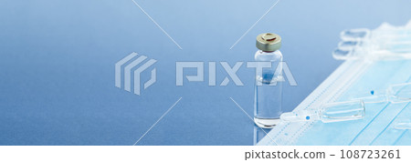 Mask and ampoules on a blue background with copy space, vaccination concept, coronavirus vaccination, ampoules. 108723261