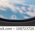 Tiny window hole with ice crystal, A close up of small bleed hole on airplane window when flying in the sky. 108723726