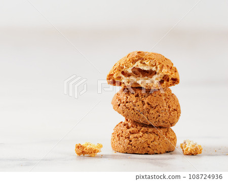 Stack of cookie amaretti on white marble background - traditional Italian Sardinian pastry. Delicious amaretti biscuit cookies made from almond or apricot kernels with copy space 108724936