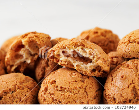 pile of cookie amaretti on white marble background - traditional Italian Sardinian pastry. Amaretti biscuit cookies made from almond or apricot kernels with copy space 108724940