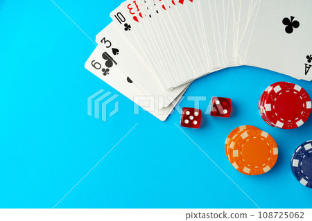 Playing cards and poker chips on blue background Playing cards and poker chips on blue background 108725062