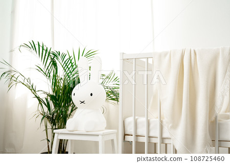 Baby wooden crib and toy rabbit in nursery room Baby wooden crib and toy rabbit in nursery room 108725460