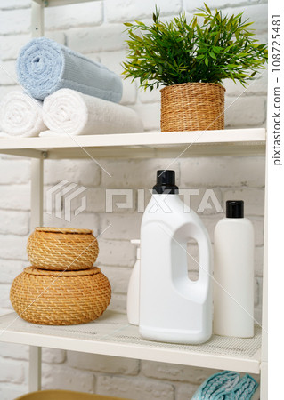 Rolled fluffy towels on shelf in bathroom 108725481