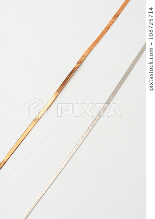 Yellow golden chain and white golden chain on paper background 108725714
