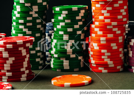Lots of poker chips on green background Lots of poker chips on green background 108725835