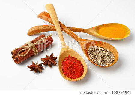 Spice in wooden spoons on white background 108725945