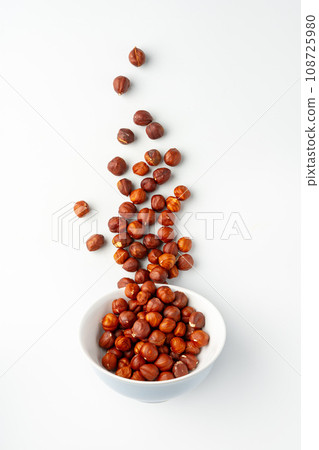 Pile of hazelnuts isolated on white background Pile of hazelnuts isolated on white background 108725980