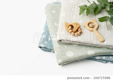 Muslin swaddle blanket with wooden toys on white background 108725996