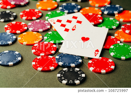 Playing cards and chips on green background Playing cards and chips on green background 108725997