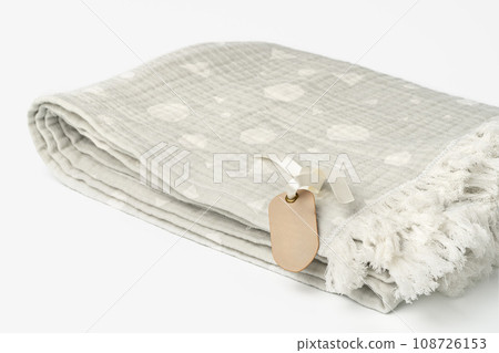 Warm cotton gray blanket with paper tag on white background 108726153