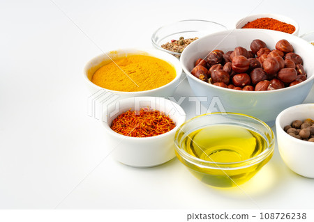 Bowls with spices and cooking ingredients on white background 108726238