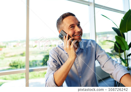 Handsome businessman speaking on the phone in office 108726242