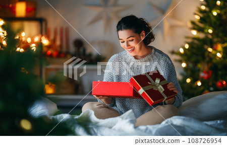 woman with Christmas present woman with Christmas present 108726954