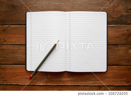 Open notebook and pencil on a rustic wooden board 108728205