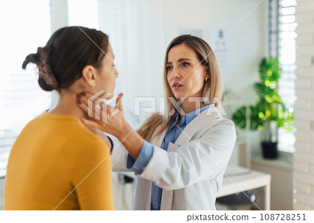 Doctor examining lymp nodes on neck of the teenage girl. Palpation of lymph nodes. Concept of preventive health care for adolescents. 108728251