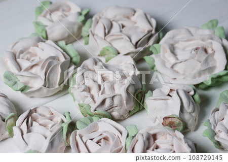 Flowers from marshmallows. Homemade marshmallows. Laid out on white boards. Flowers from marshmallows. Homemade marshmallows. Laid out on white boards. 108729145