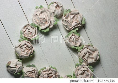 Flowers from marshmallows. Homemade marshmallows. Laid out in the shape of a heart. On white boards. Photographed from above. Flowers from marshmallows. Homemade marshmallows. Laid out in the shape of a heart. On white boards. Photographed from above. 108729150