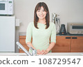 Young woman standing in the kitchen 108729547
