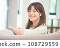 A woman relaxing on a sofa in the living room 108729559