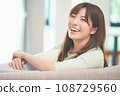 A woman relaxing on a sofa in the living room 108729560