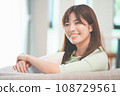 A woman relaxing on a sofa in the living room 108729561