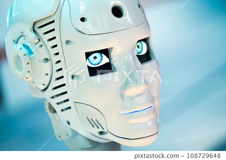 Closeup of white illuminated human robot looking away against blurred background 108729648