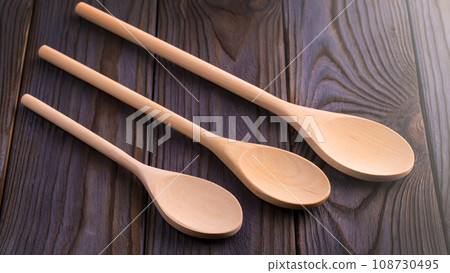 Wood spoons on wooden table. Kitchen utensils on soft sunlight Wood spoons on wooden table. Kitchen utensils on soft sunlight 108730495