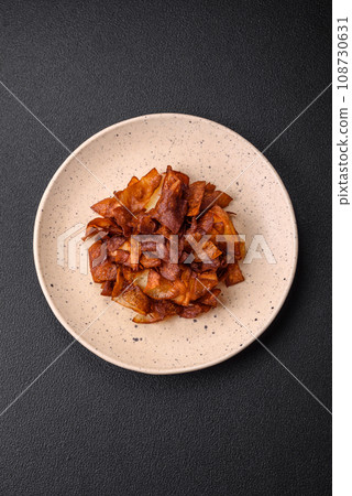 Delicious crispy potato chips with salt and spices Delicious crispy potato chips with salt and spices 108730631