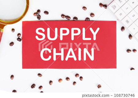 SUPPLY CHAIN writing on a red card on a white background with coffee beans and a magnifying glass 108730746
