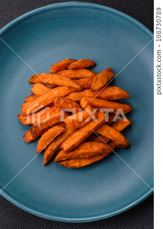 Delicious crispy sweet potato fries with salt, spices and herbs Delicious crispy sweet potato fries with salt, spices and herbs 108730789