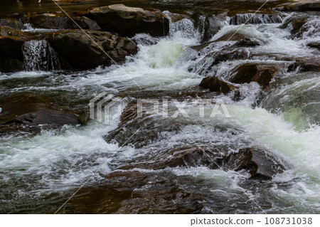 The stream of water flowing over rocks.Image close-up 108731038