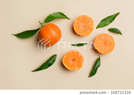 Many fresh ripe mandarin with green leaves on colored background, top view, space for text Many fresh ripe mandarin with green leaves on colored background, top view, space for text 108731326