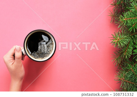 High angle of woman hands holding coffee mug on pink background Minimalistic style. Flat lay, top view isolated High angle of woman hands holding coffee mug on pink background Minimalistic style. Flat lay, top view isolated 108731332