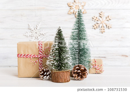 Christmas composition. Gifts, small tree, branches and craft DIY decorations on white background. New year concept. Christmas home decoration Flat lay, top view, copy space Christmas composition. Gifts, small tree, branches and craft DIY decorations on white background. New year concept. Christmas home decoration Flat lay, top view, copy space 108731530