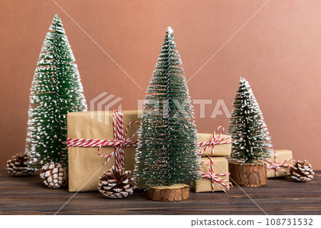 Christmas composition. Gifts, small tree, branches and craft DIY decorations on white background. New year concept. Christmas home decoration Flat lay, top view, copy space 108731532