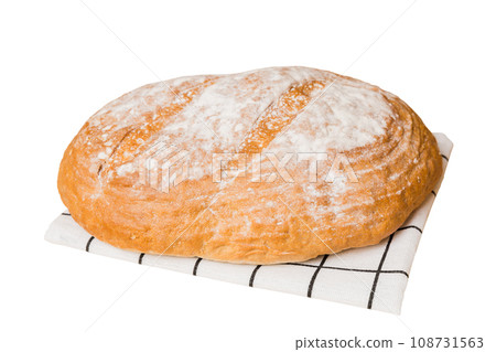 Freshly baked delicious french bread with napkin isolated on white background top view. Healthy white bread loaf 108731563