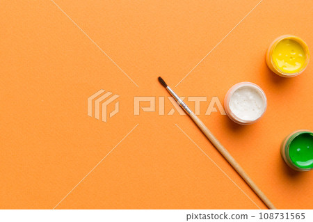 art palette with paint and brushes, close up. Top view with empty space. workplace for creativity. home teaching concept drawing art palette with paint and brushes, close up. Top view with empty space. workplace for creativity. home teaching concept drawing 108731565