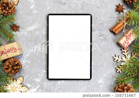 Digital tablet mock up with rustic Christmas gray cement background decorations for app presentation. top view with copy space Digital tablet mock up with rustic Christmas gray cement background decorations for app presentation. top view with copy space 108731667